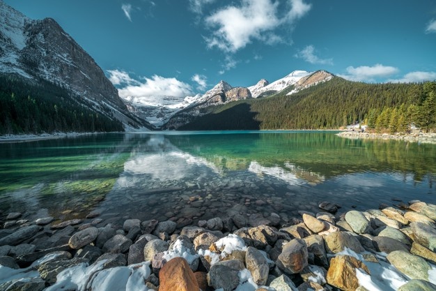 breathtaking-shot-beautiful-stones-turquoise-water-lake-hills-background_181624-12847