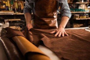 close-up-cobbler-working-with-leather-textile_171337-12258