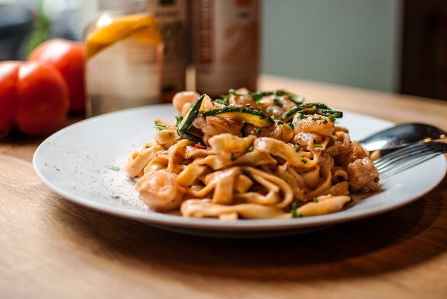 closeup-shot-delicious-pasta-white-plate_181624-42152