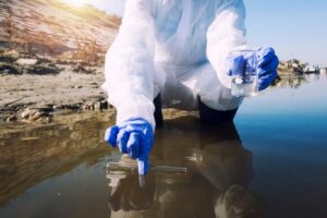 ecologist-taking-samples-water-with-test-tube-from-city-river-determine-level-contamination-pollution_342744-952