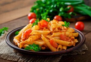 penne-pasta-tomato-sauce-with-chicken-tomatoes-wooden-table_2829-19739