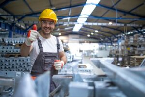 portrait-factory-worker-protective-equipment-holding-thumbs-up-production-hall_342744-147