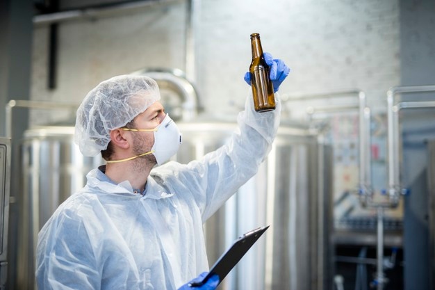 technologist-checking-beer-quality-brewery_342744-1233